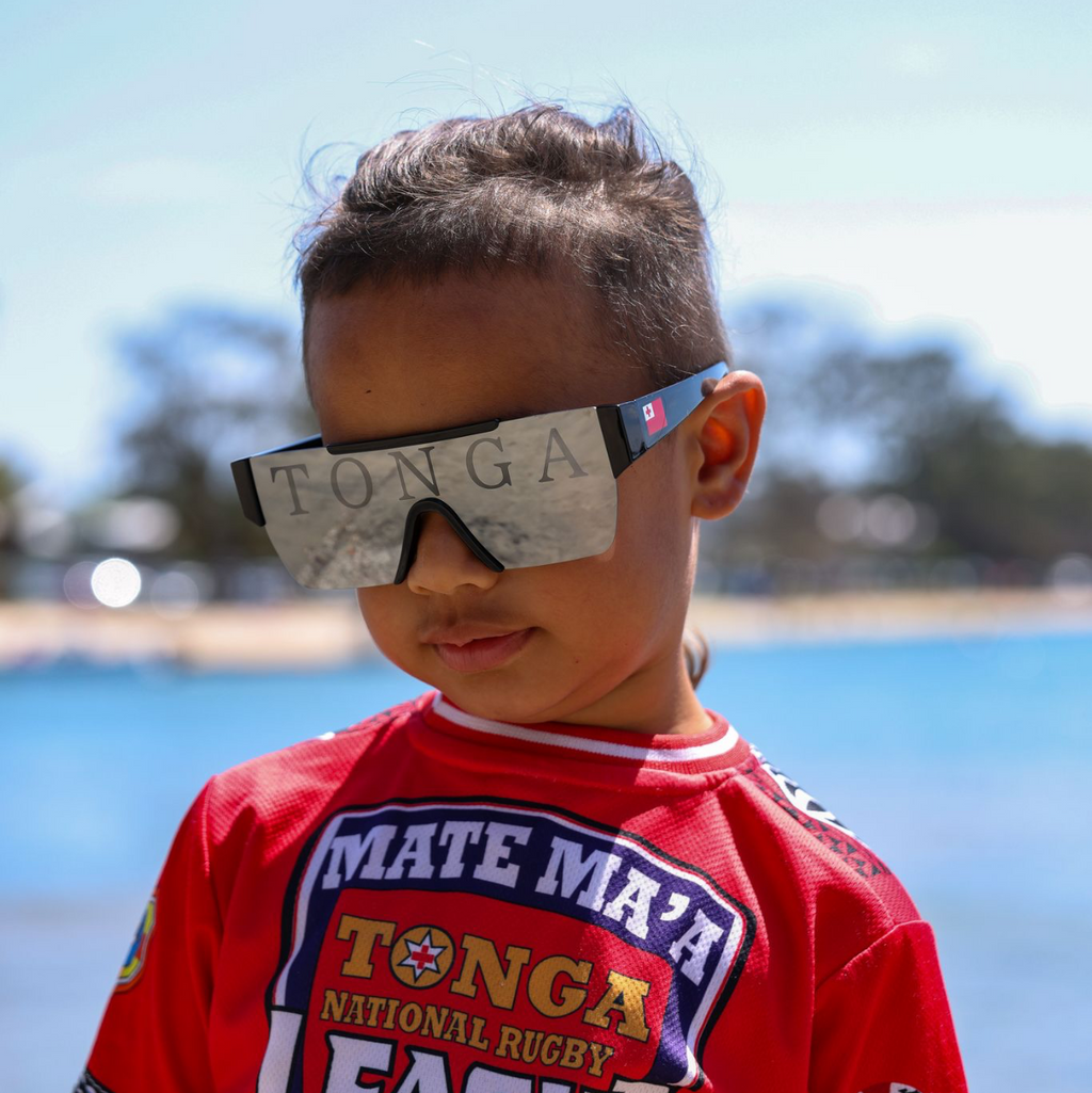 Tonga Edition WAVY SHADES — bold cultural eyewear inspired by Tongan pride and island heritage. Featuring panoramic TONGA imprint, national colours, and lightweight summer-ready design. Pacific-owned. Built for culture, family and the next generation.